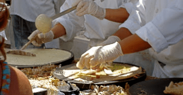 Multiple chef preparing Italian food