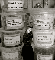 A black and white photo of plastic containers with labels on them.
