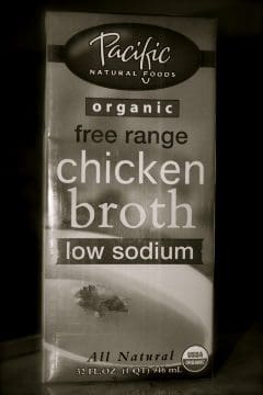 A box of pacific free range chicken broth on a table.