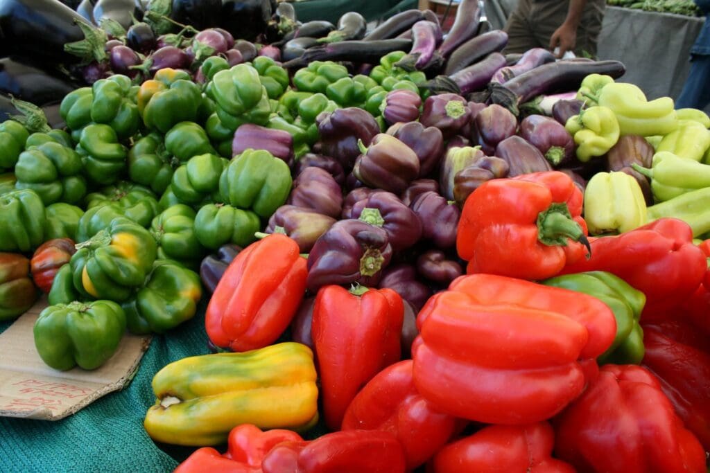 A bunch of colorful peppers on a table.