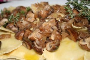 Enjoy a plate of ravioli with mushrooms and thyme.