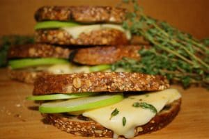 A stack of toasted sandwiches with apples and thyme.