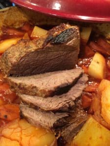A traditional pot roast recipe simmering on a stove.