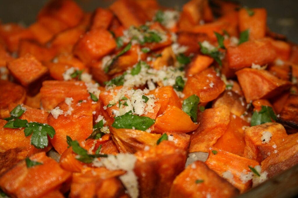 Indulge in a delicious roasted sweet potato dish garnished with parsley for a flavorful twist.