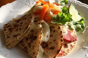 Try this delicious corned beef quesadilla recipe with a variety of vegetables on a plate.