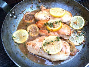 Try this flavorful lemon chicken recipe made by cooking chicken in a skillet with lemon slices and herbs.