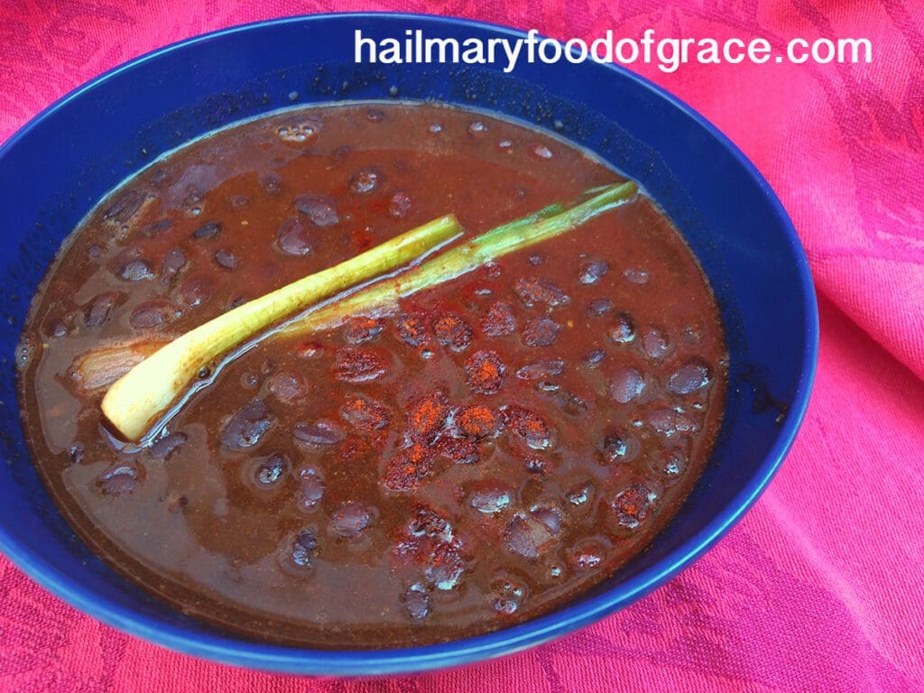 A bowl of black bean soup with a spoon.
