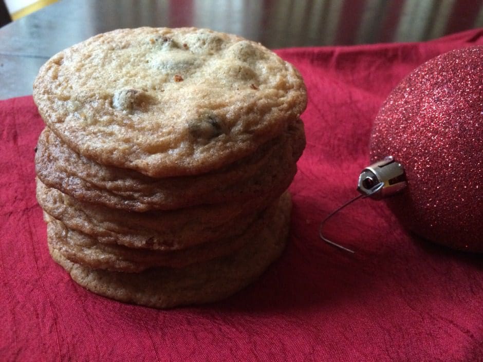 A stack of cookies and a christmas ornament.