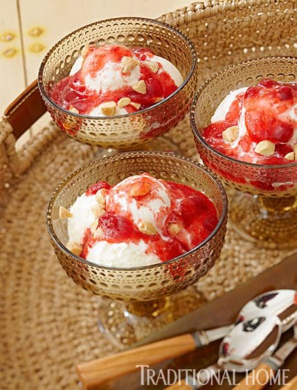 Three bowls of strawberry ice cream on a tray.