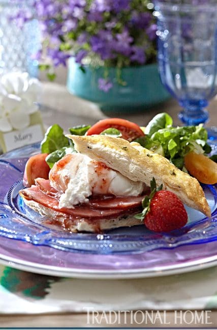 a plate of ham, egg, and fruits