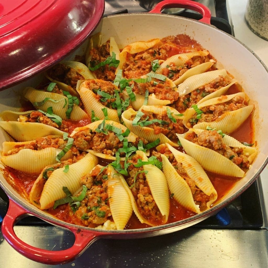 a pan of Baked stuffed shells with Italian sausage