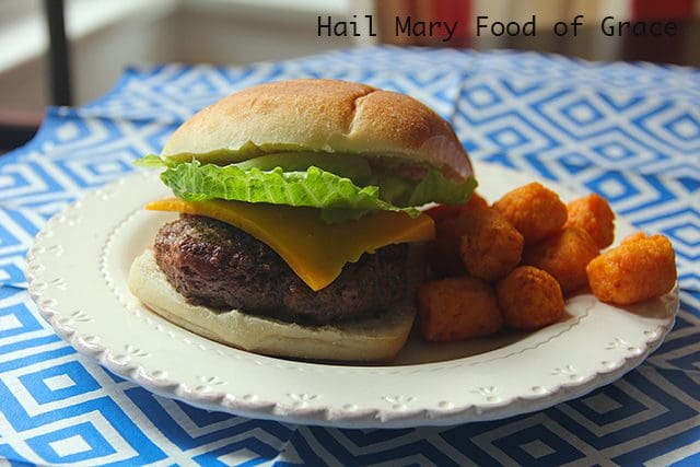 a burger and tater tots on a plate