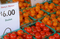 Tomatoes for sale at a farmers' market.