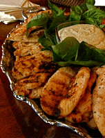Grilled chicken on a silver platter.