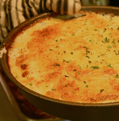 A pan with a cheesy dish in it.