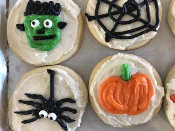 Halloween cookies decorated with icing and decorations.