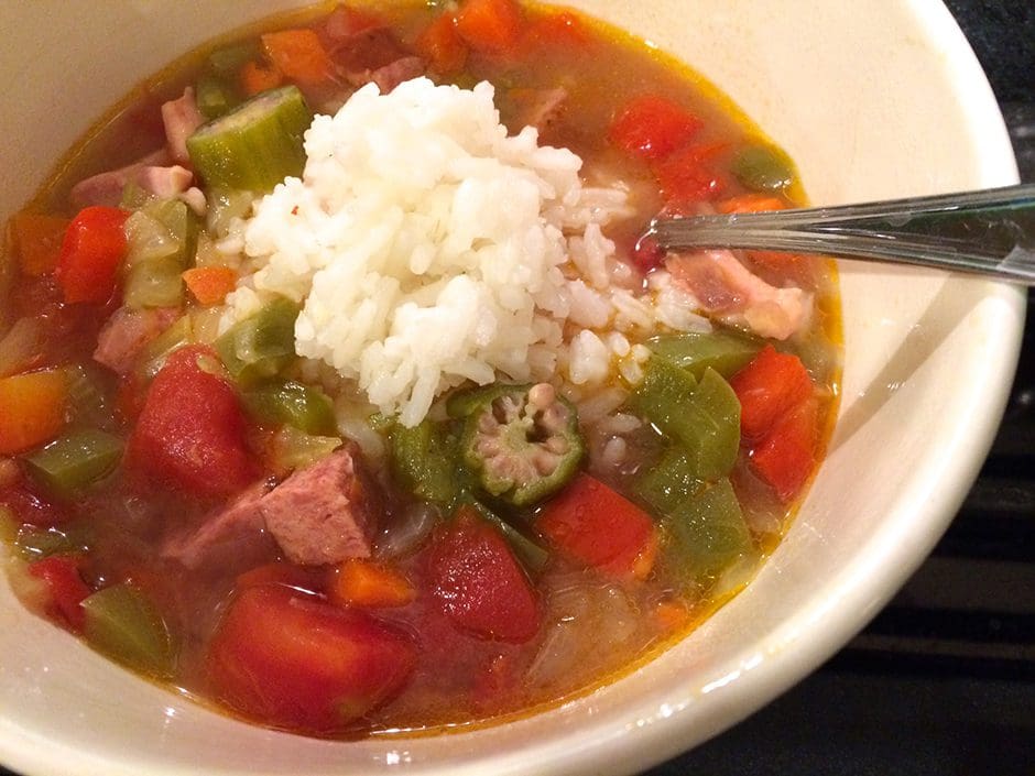 A bowl of soup with rice and vegetables.