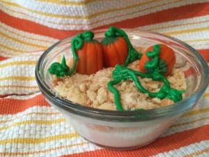 A bowl filled with pumpkins and icing.