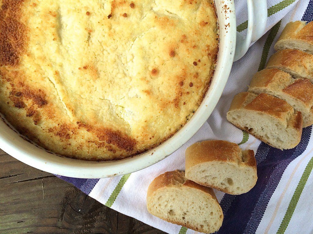 A white dish with bread next to it.