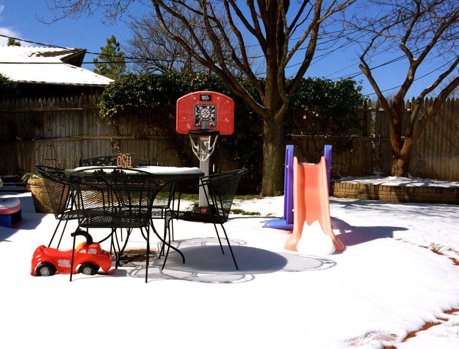 A backyard covered in snow.
