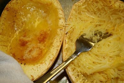 Two squash boats with noodles and a fork.