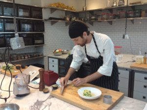 A chef is preparing food in a kitchen.