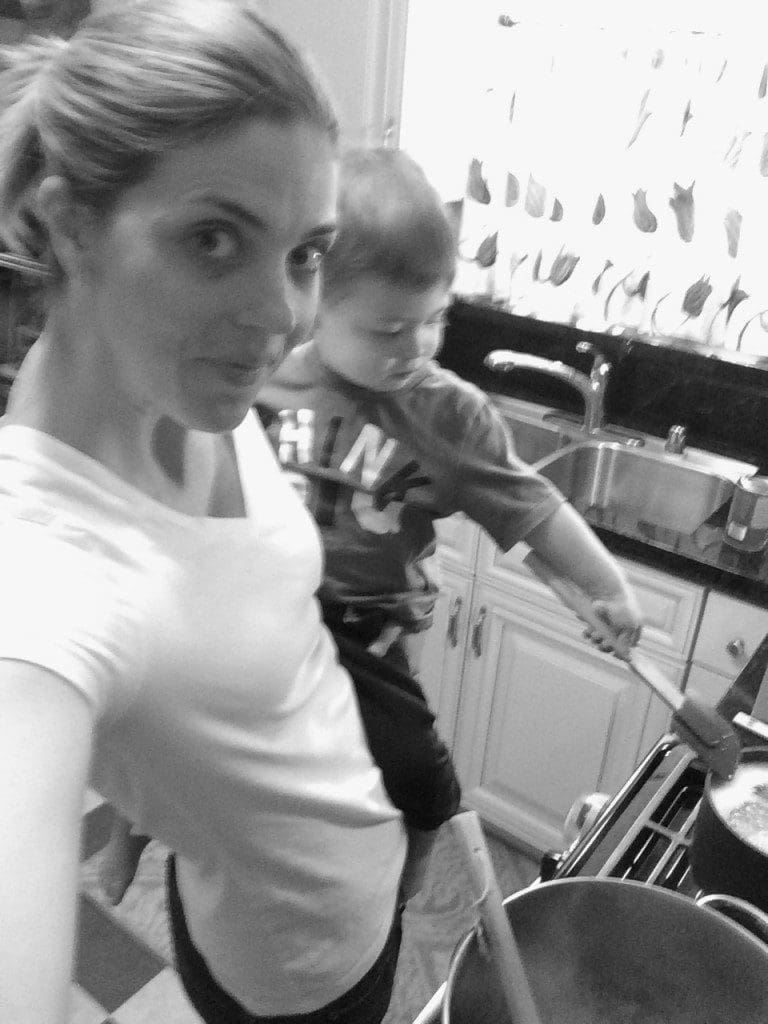 A woman and a child in a kitchen.