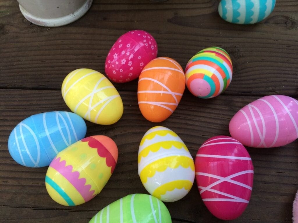 A group of colorful painted easter eggs on a wooden table.
