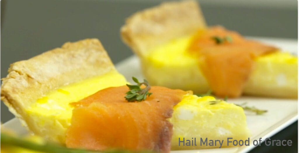 Smoked salmon quiche on a white plate.