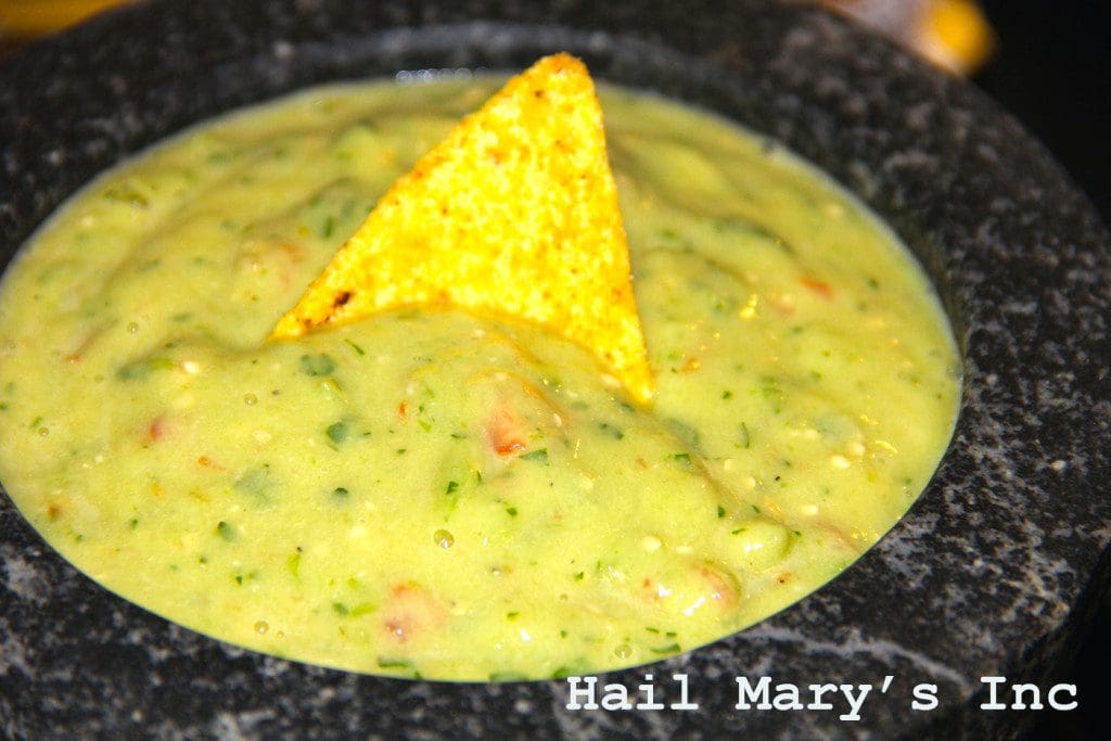 Guacamole in a bowl with tortilla chips.