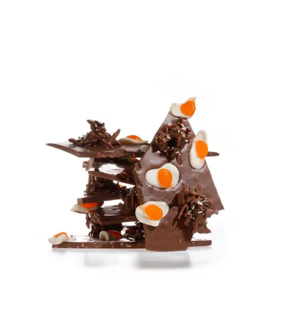 A chocolate sculpture with eggs on top of it.