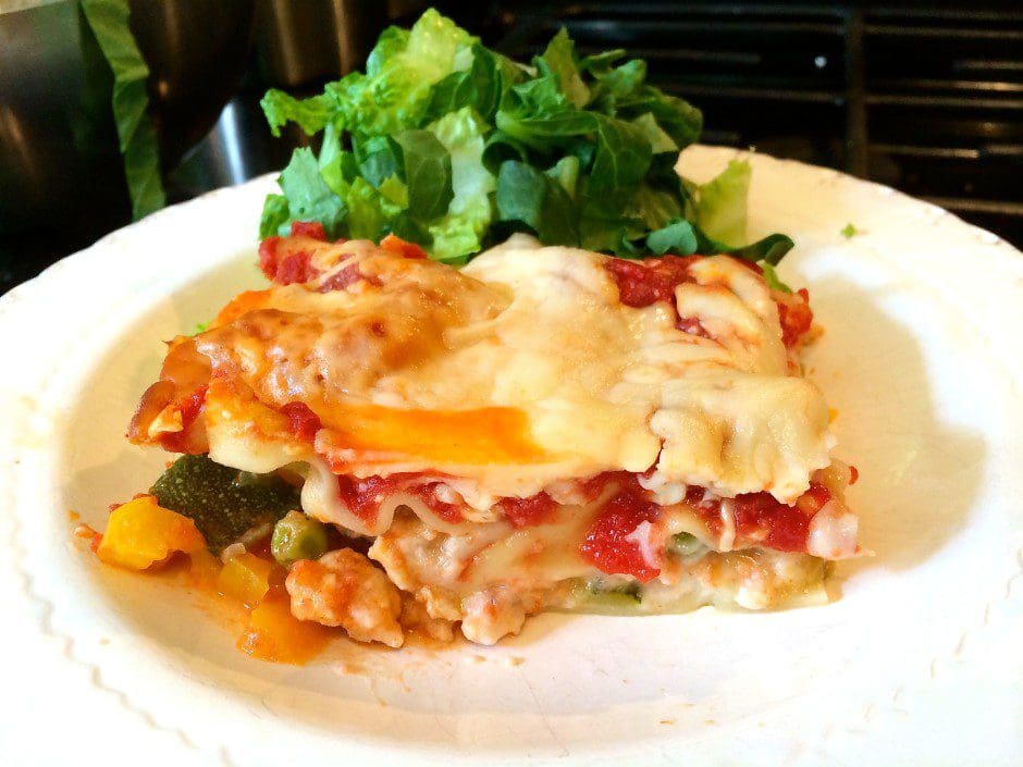 A plate with a piece of lasagna on it.