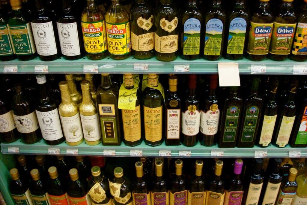 Many bottles of wine are on display in a store.