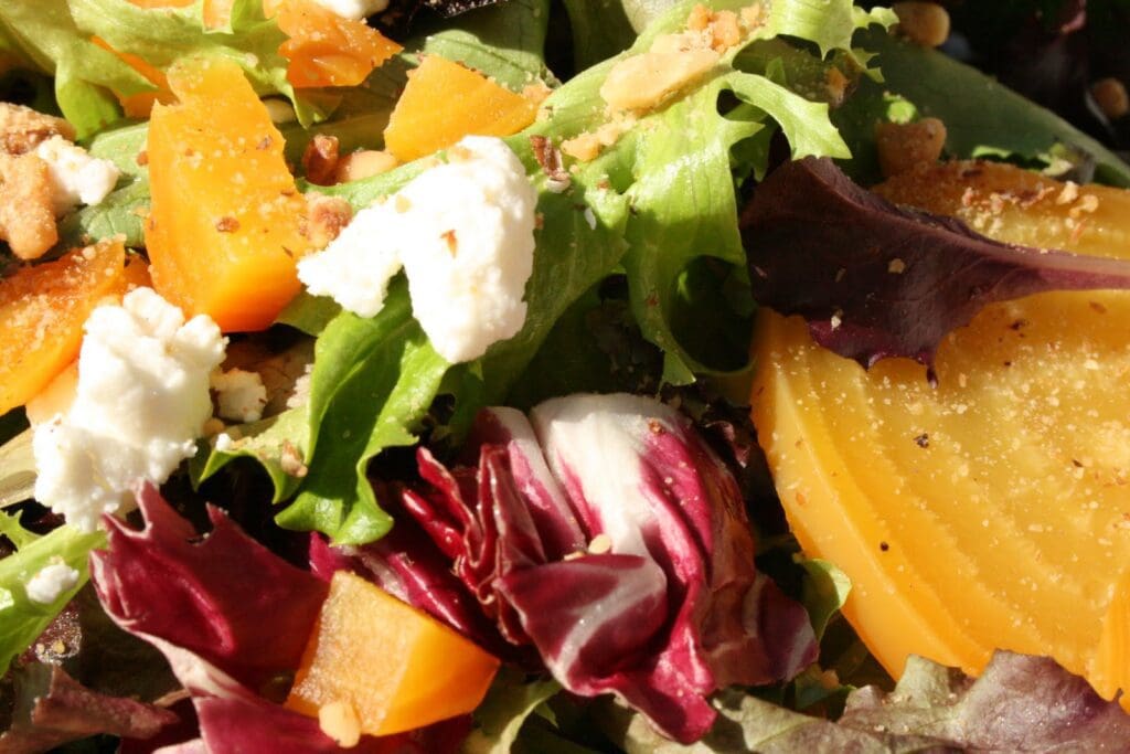 A salad with carrots, beets, walnuts and feta cheese.