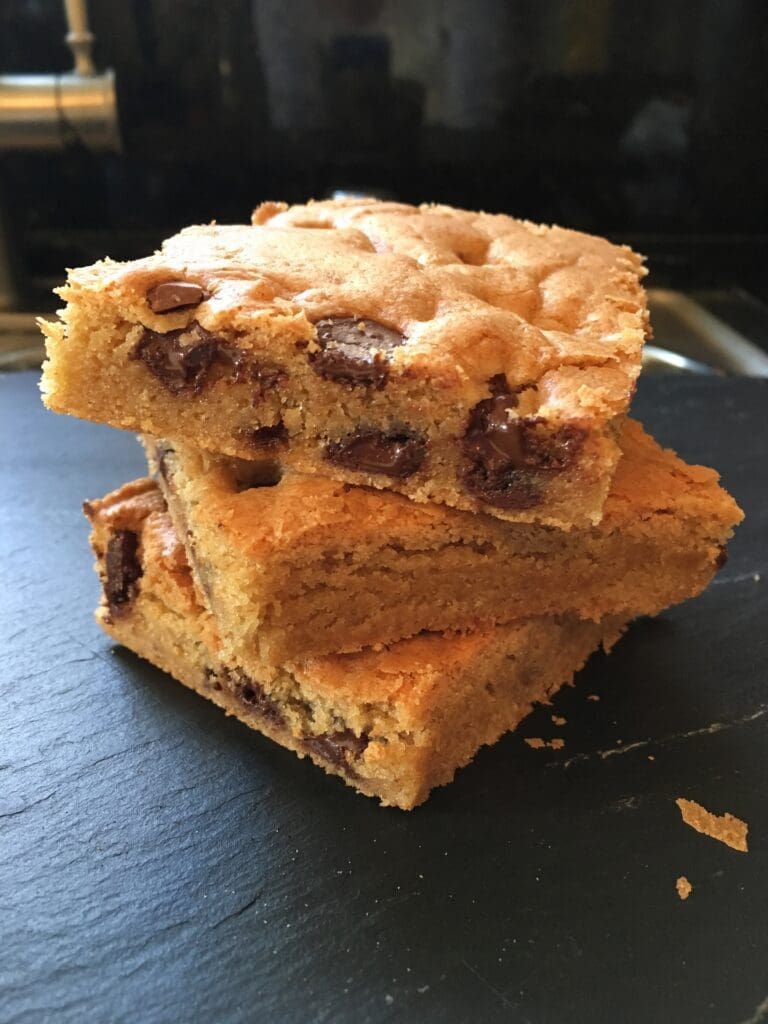 three bars of blonde brownies on a plate