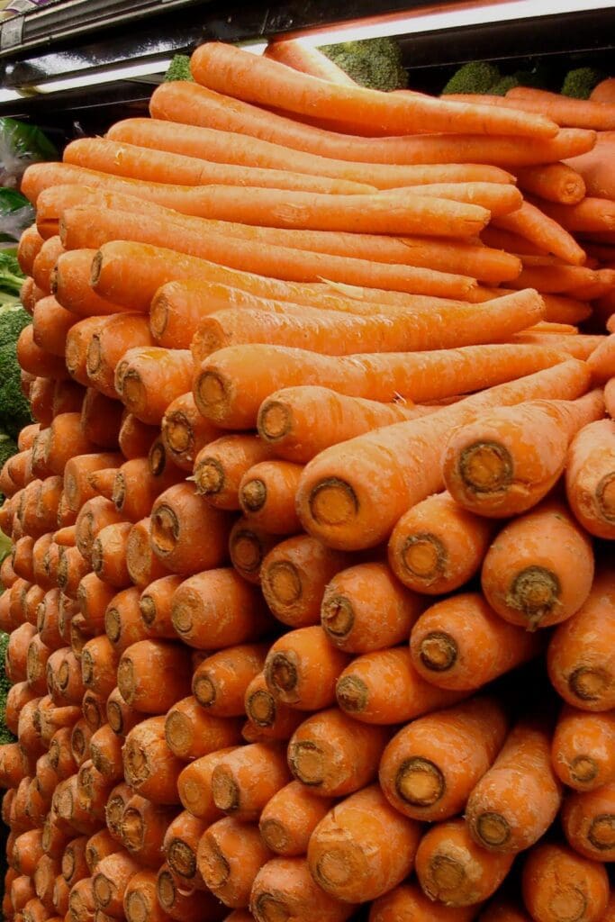 A pile of carrots in a grocery store.
