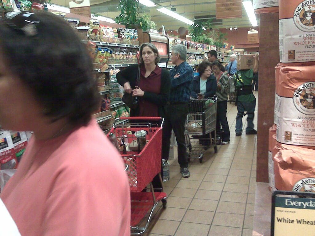 A group of people in a grocery store.