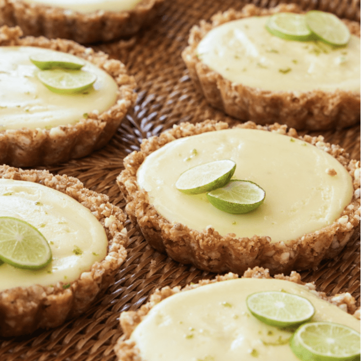 A group of lime tarts on a wicker basket.