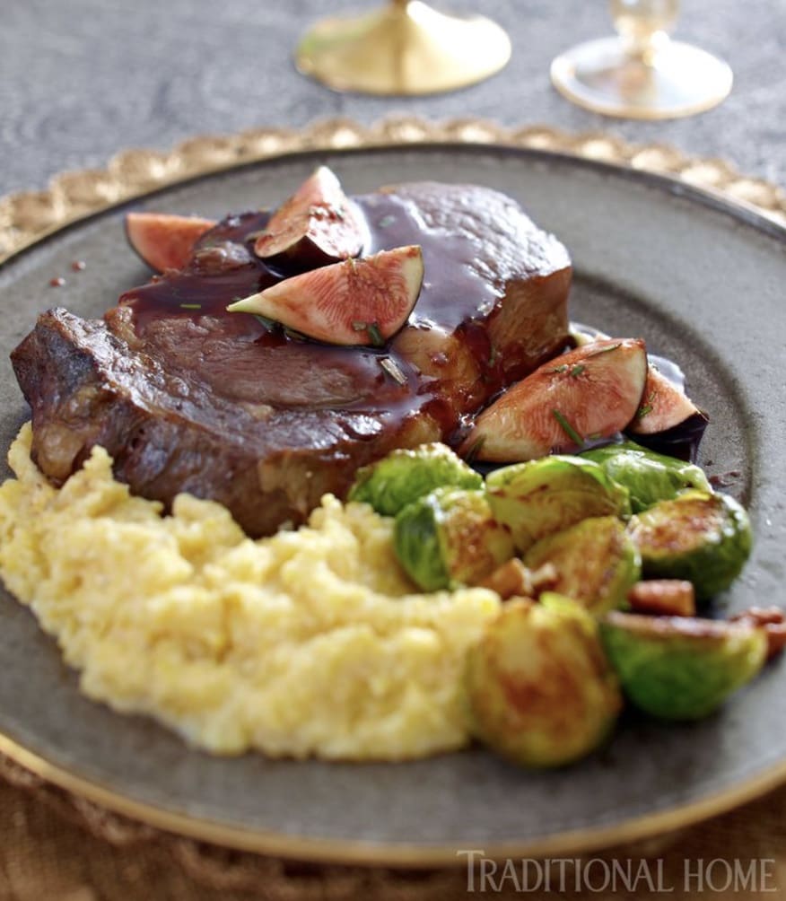 Steak with figs and brussels sprouts on a plate.