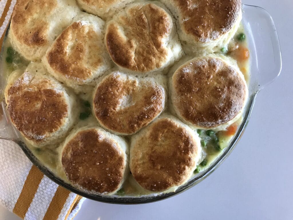 Biscuit-topped chicken pot pie in baking dish.