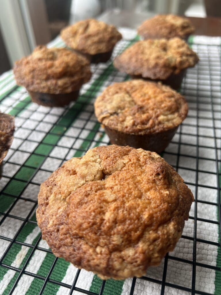 Freshly baked muffins cooling on a wire rack.