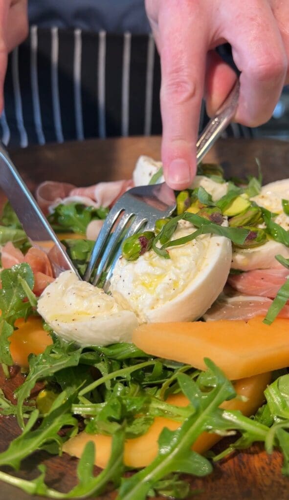 A close-up of a fresh salad with sliced boiled egg and vegetables.