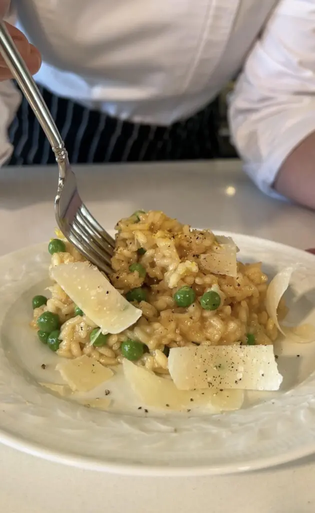 Creamy risotto with peas and shaved Parmesan cheese.