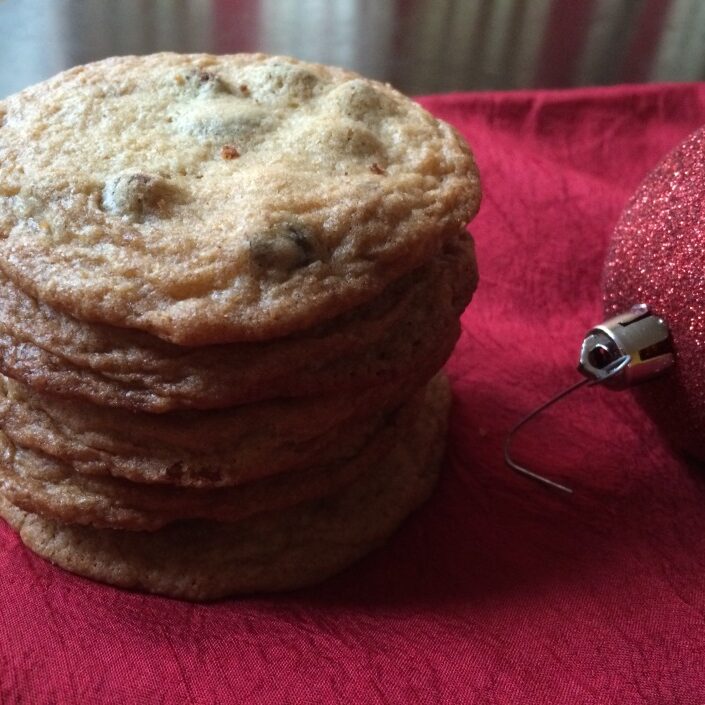 A stack of cookies and a christmas ornament.