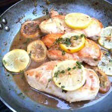 Try this flavorful lemon chicken recipe made by cooking chicken in a skillet with lemon slices and herbs.