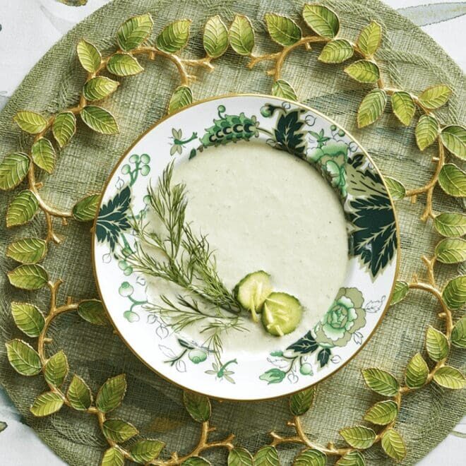 A plate with a bowl of soup on it.