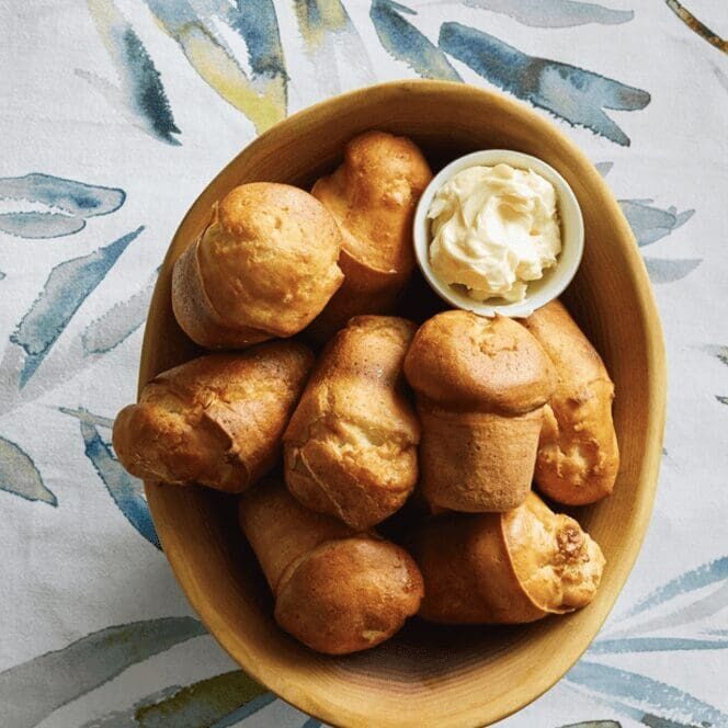 A wooden bowl filled with bread and dip.