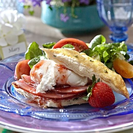 a plate of ham, egg, and fruits