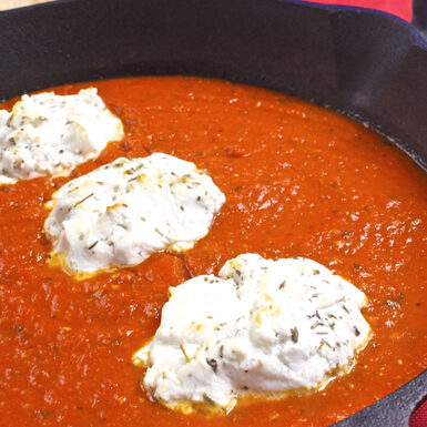 Goat cheese and tomato sauce in a pan